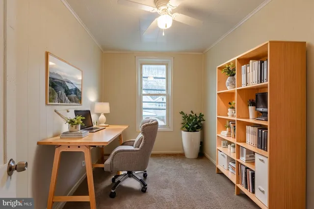 a view of a dining room with furniture and a window