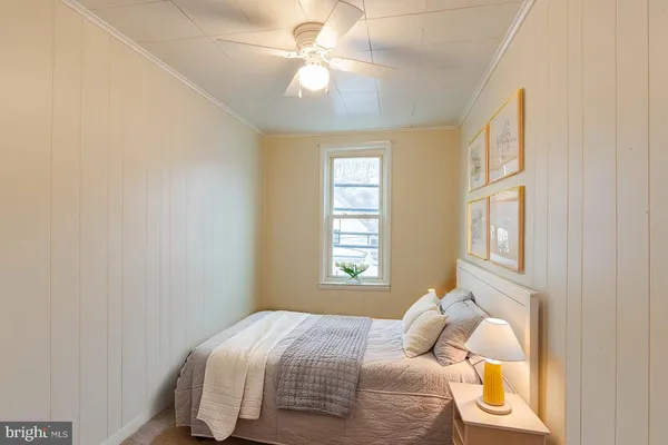 a bedroom with a bed and a window