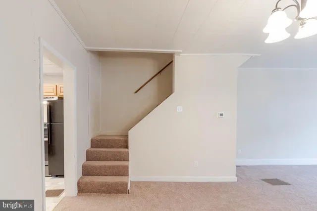a view of staircase with white walls