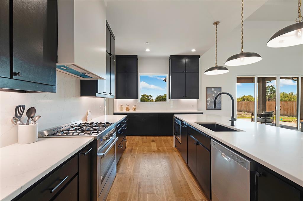 430 Whispering Way Red Oak, TX 75154 - Photo 20 of 40 Contemporary kitchen featuring dark cabinetry, white countertops, and wood-finish flooring