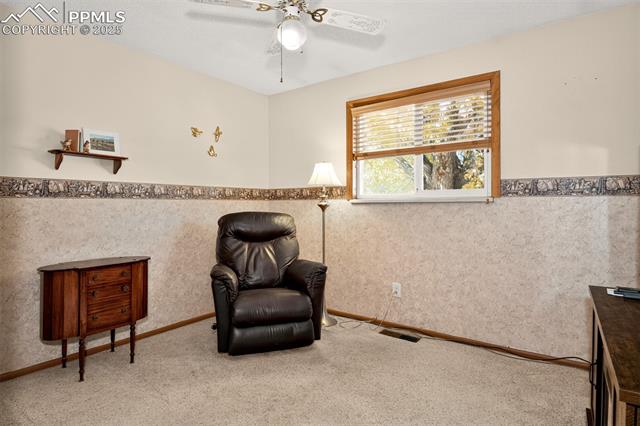 6723 Seneca Road Colorado Springs, CO 80915 - Photo 15 of 36 Second main level bedroom with decorative ceiling fane and wallpaper