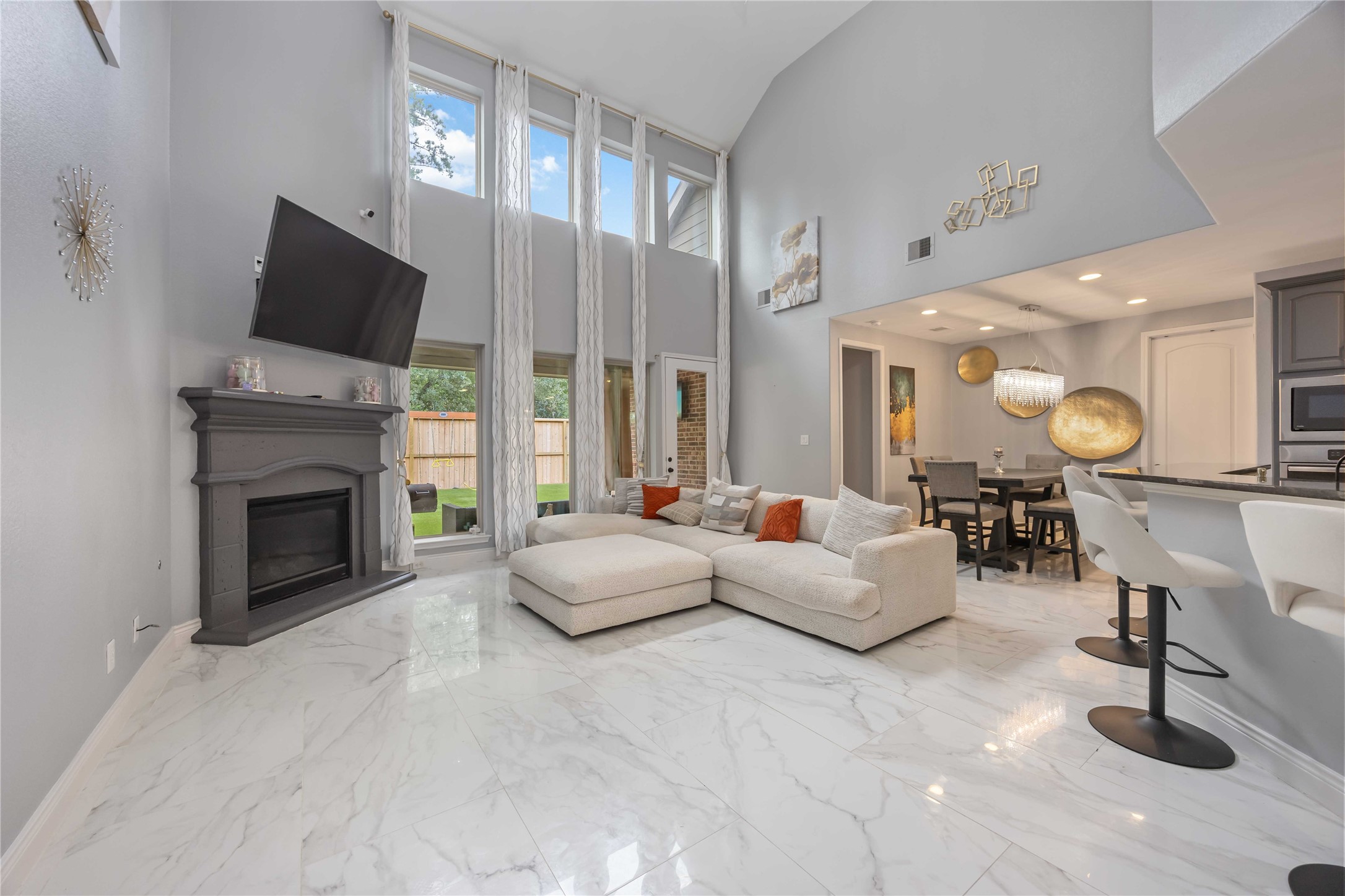 a living room with fireplace furniture and a flat screen tv
