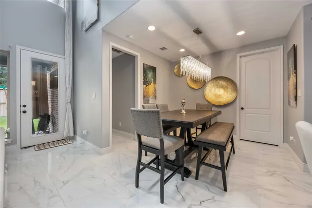 a view of a dining room with furniture and a mirror