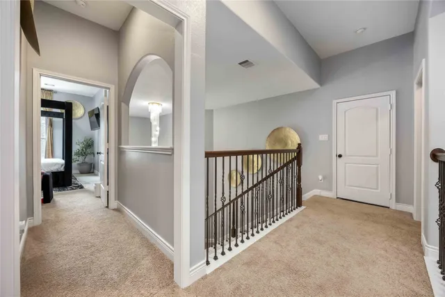 a view of a hallway view with wooden floor and staircase