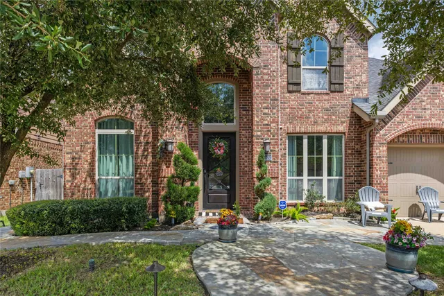 a front view of a house with outdoor seating