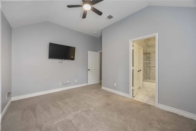 a bedroom with two beds and a bed