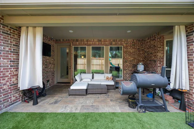 a view of a house with backyard sitting area and garden