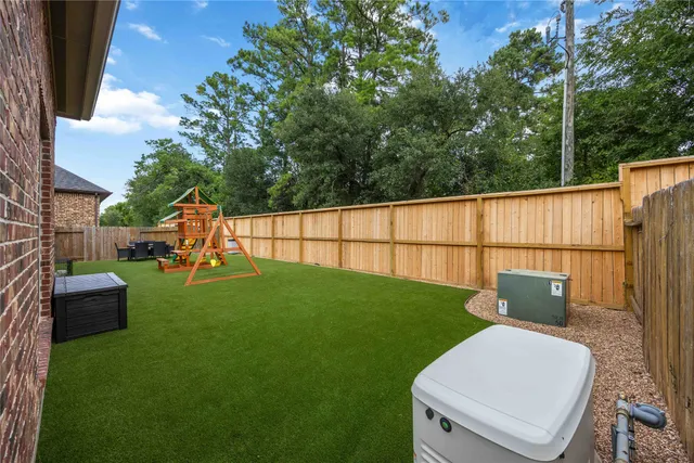a view of a backyard with wooden fence