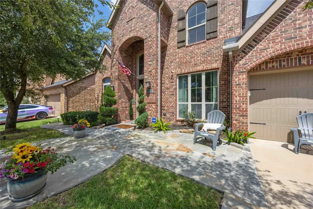 a view of a house with backyard and sitting area