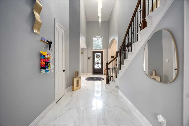 a view of entryway and hall with wooden floor