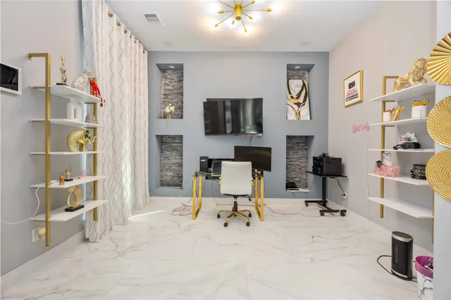 a view of a livingroom with workspace and a couch