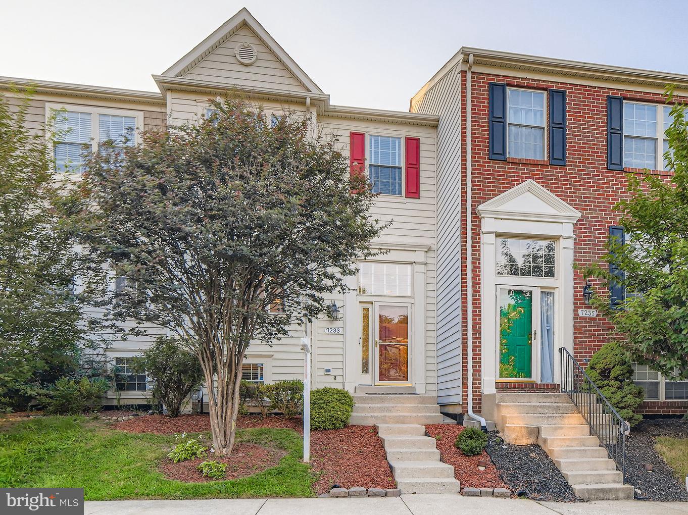 7233 Calm Sunset Columbia, MD 21046 - Photo 1 of 1 a front view of a house with garden