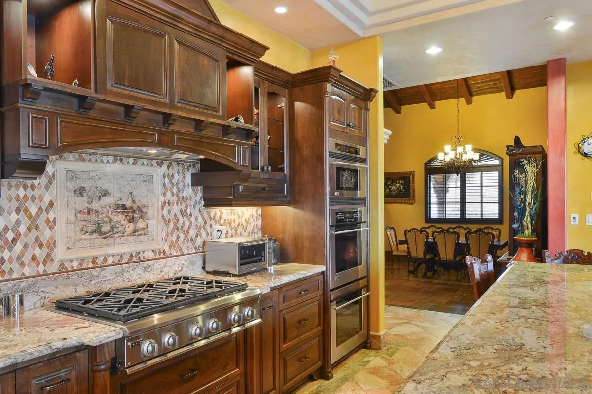 14545 Highway 67 Poway, CA 92064 - Photo 16 of 58 a kitchen with stainless steel appliances granite countertop a stove a sink and a refrigerator