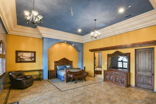 a view of a livingroom with furniture chandelier and window