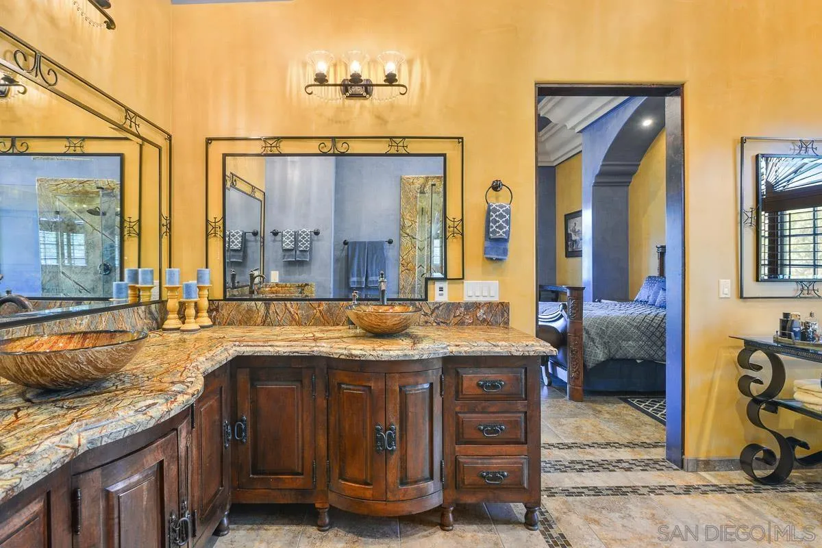 14545 Highway 67 Poway, CA 92064 - Photo 23 of 58 a bathroom with a granite countertop sink and a mirror