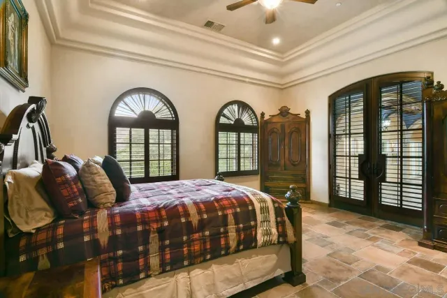 a bedroom with furniture and a mirror