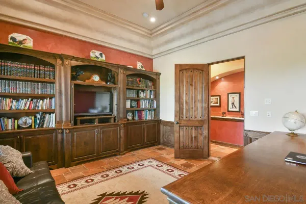 a view of a house with a yard and potted plants