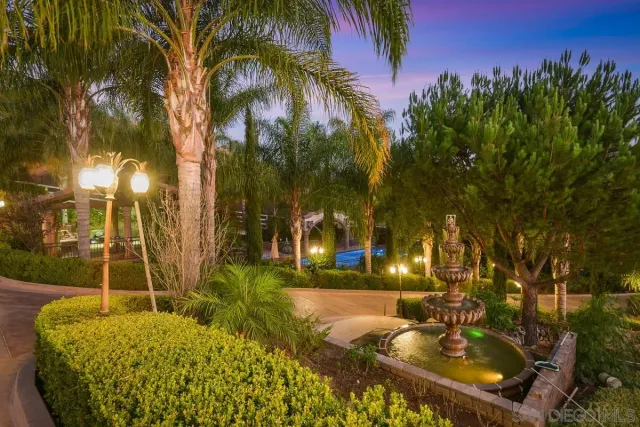 an aerial view of a house with a mountain