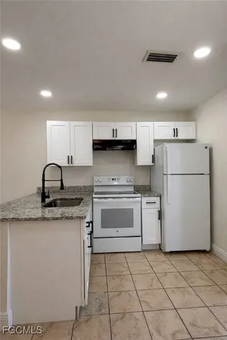 a kitchen with a sink a stove and refrigerator