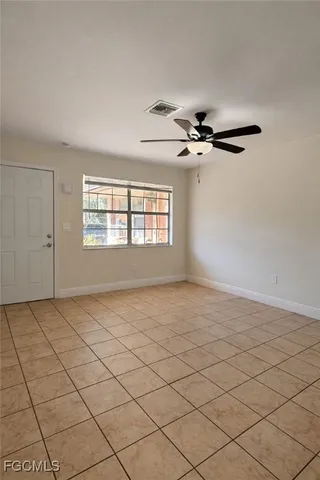 a view of a livingroom with a ceiling fan and window