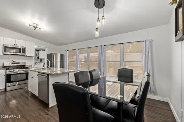 a living room with furniture flat screen tv and window