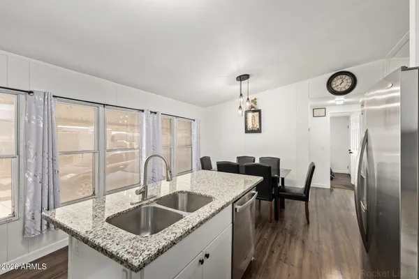 a kitchen with granite countertop a sink and cabinets