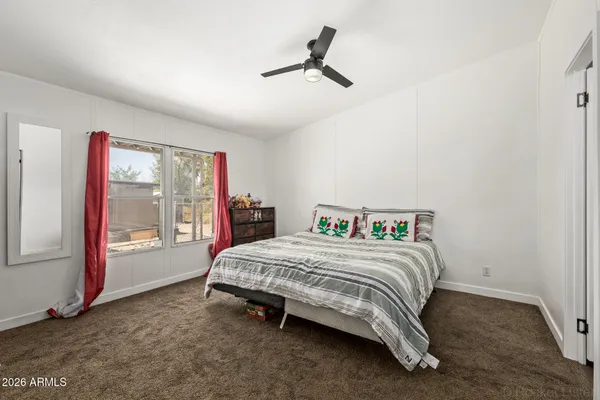 a bedroom with a bed and a large window