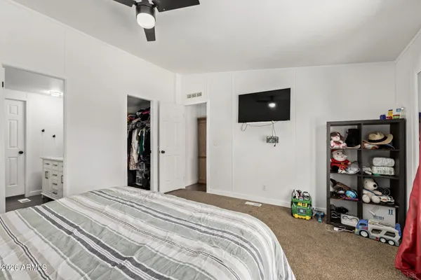 a bedroom with a bed and a flat screen tv