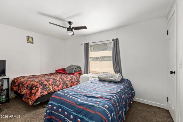 a bedroom with two beds and a window