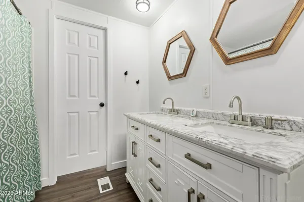 a bathroom with a granite countertop sink and a mirror