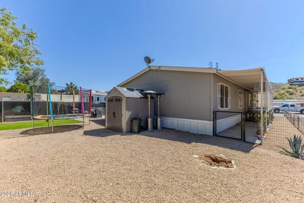 a view of a house with a backyard and a patio