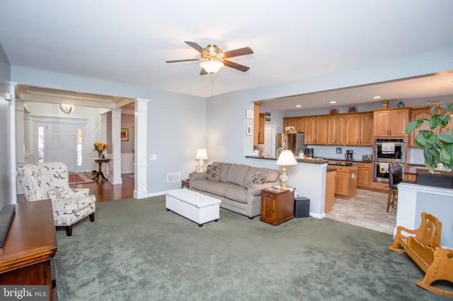a living room with fireplace furniture and a large window