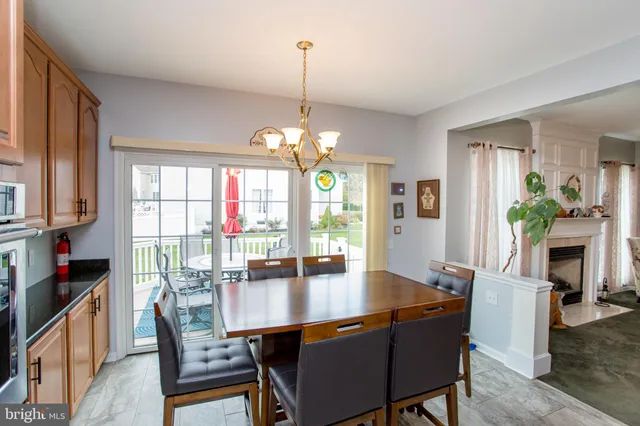 a dining room with furniture a window and a chandelier