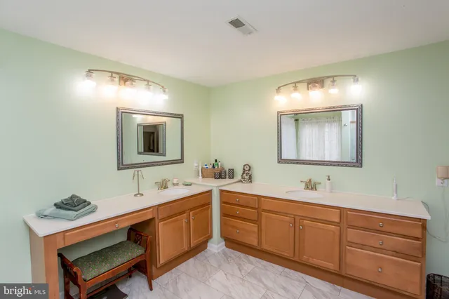 a spacious bathroom with a double vanity sink double and mirror
