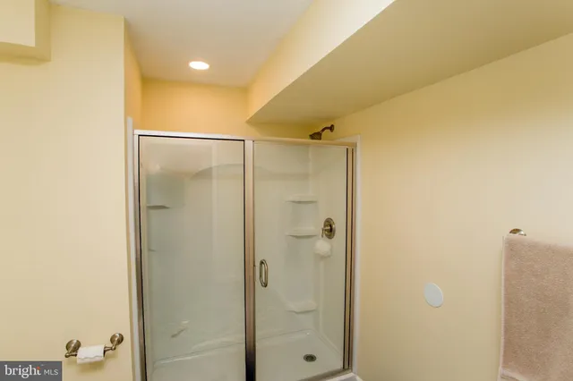 a bathroom with a shower and a glass door
