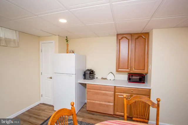 a bathroom with a toilet a sink a mirror a vanity and shower