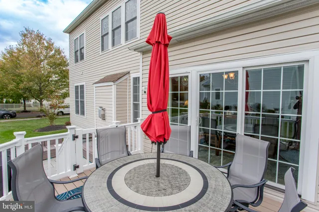 a table and chairs in front of a house
