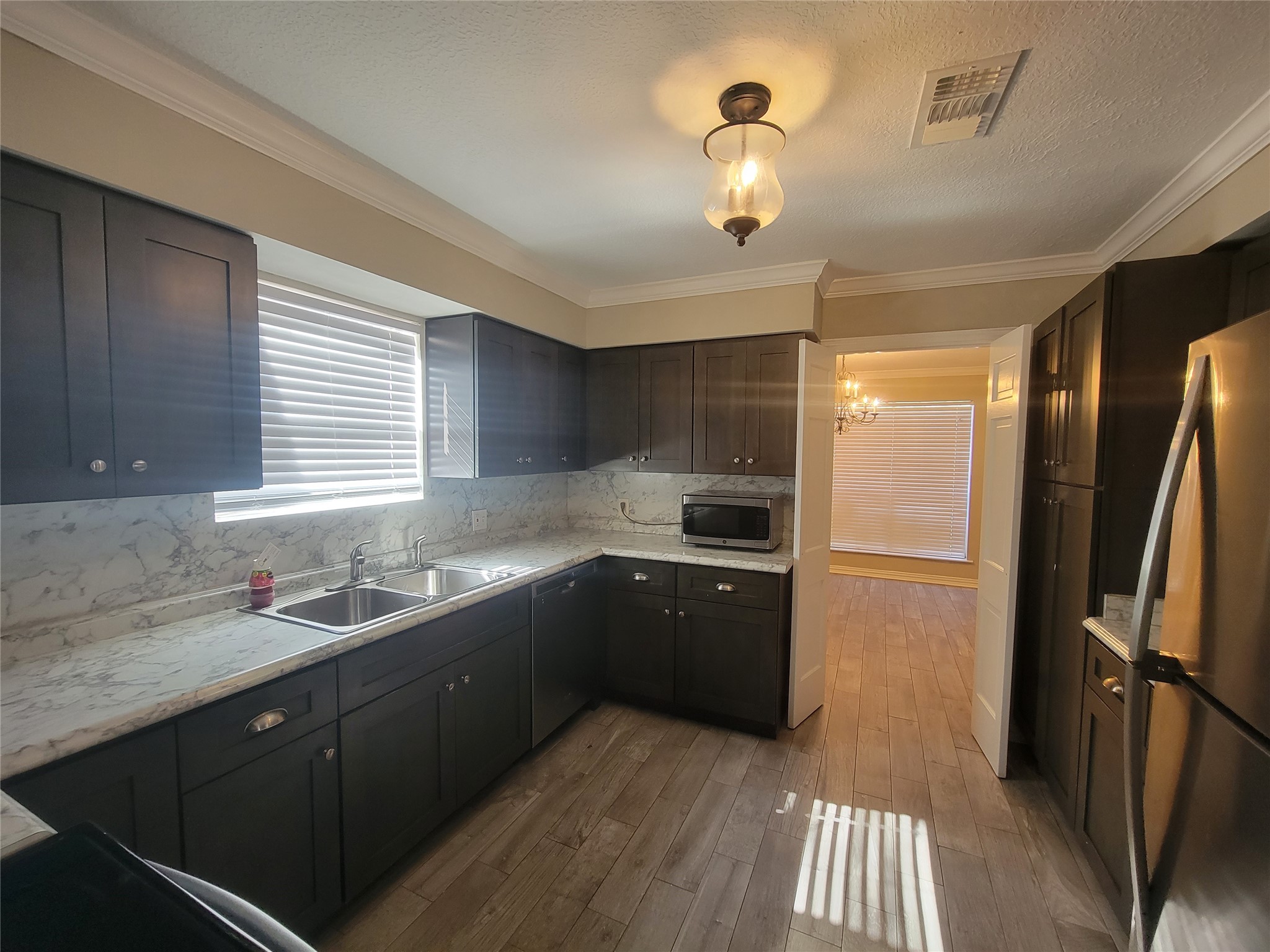 4015 Chapel Square Drive Spring, TX 77388 - Photo 12 of 27 Discover a kitchen with rich cabinetry that beautifully complements the countertops and sleek stainless steel appliances.