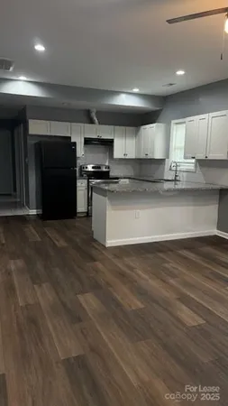 a kitchen with stainless steel appliances kitchen island granite countertop a stove a sink and a microwave