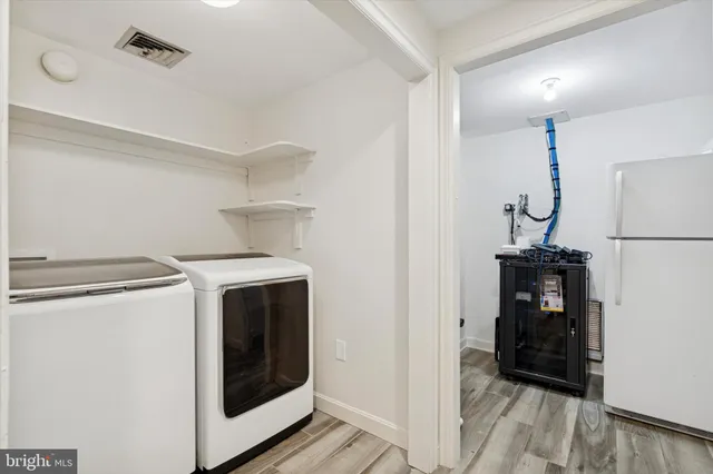 a view of a storage & utility room with washer and dryer