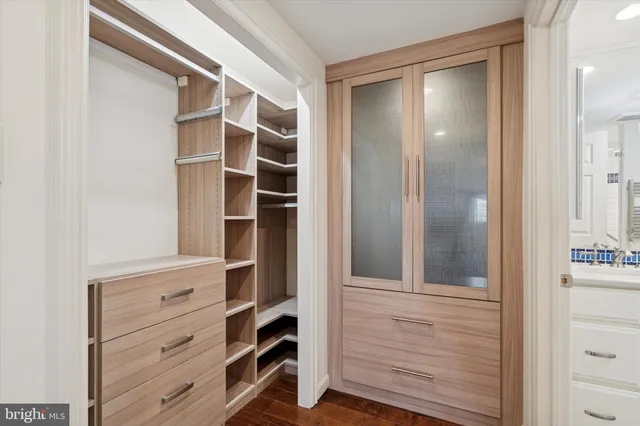 a view of walk in closet with empty racks