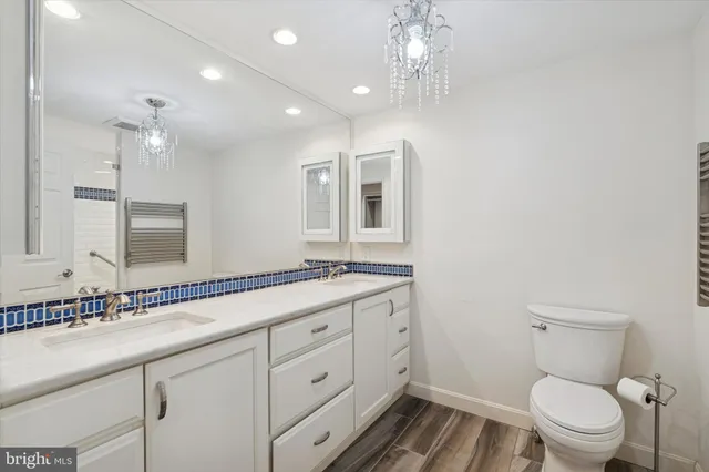 a bathroom with a toilet a sink and mirror
