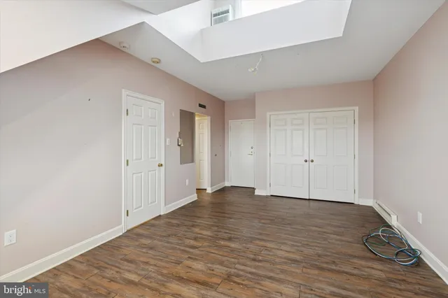 a view of an empty room and wooden floor