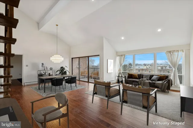 a living room with fireplace furniture and a large window