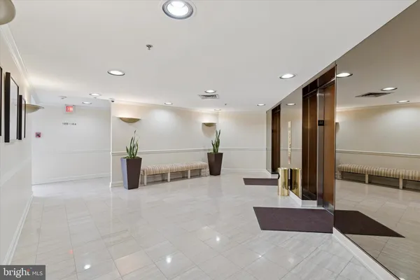 a lobby with a couch and a rug