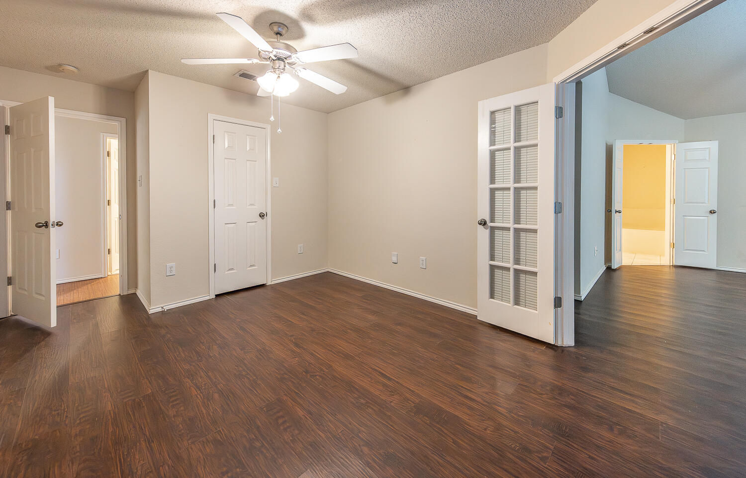 5815 89th Street Lubbock, TX 79424 - Photo 14 of 31 an empty room with wooden floor chandelier fan and windows