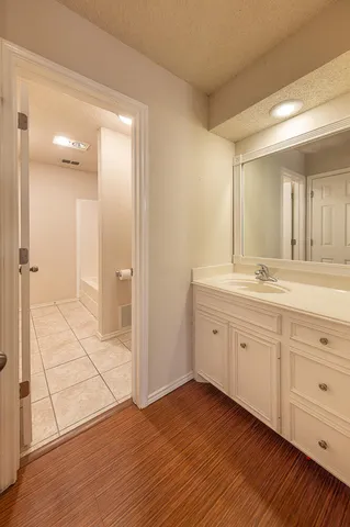 a spacious bathroom with a double vanity sink a mirror and a shower