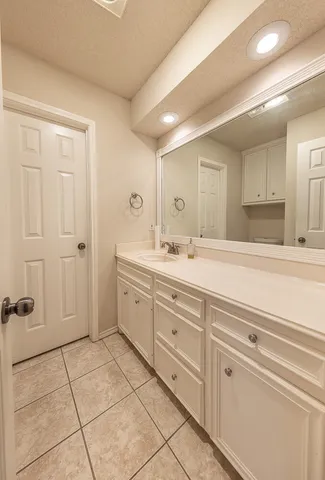 a bathroom with a sink a mirror and a shower
