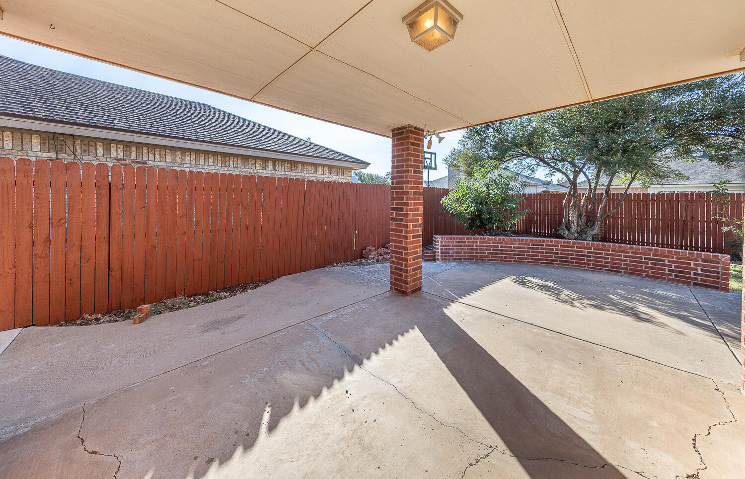 5815 89th Street Lubbock, TX 79424 - Photo 26 of 31 a view of backyard with a tub and wooden fence