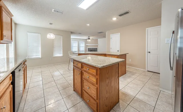 a kitchen with stainless steel appliances granite countertop a sink and a stove top oven